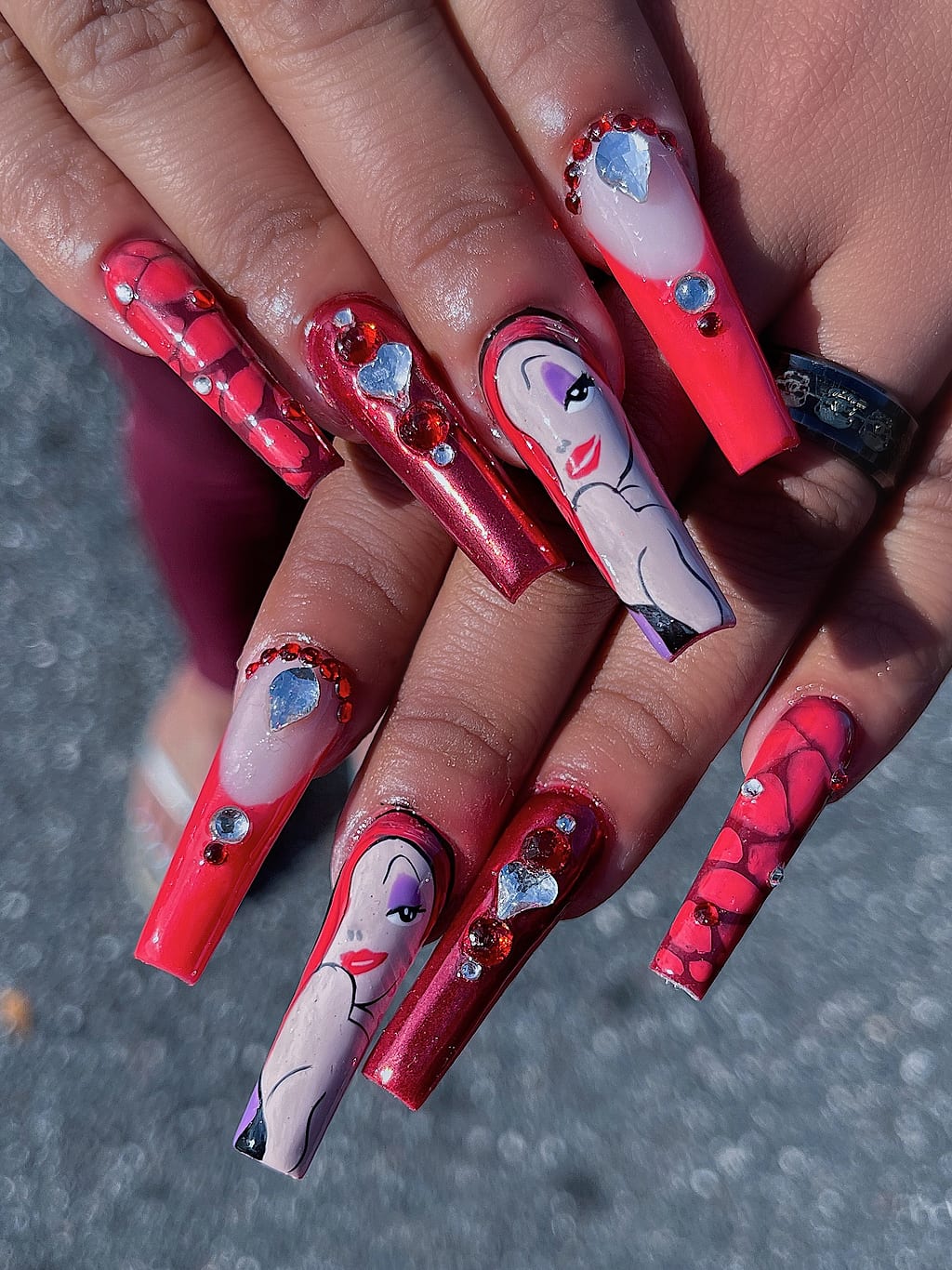 Red coffin nails with hand-painted portrait art and gems at Palace Nail Spa in Midtown Tallahassee