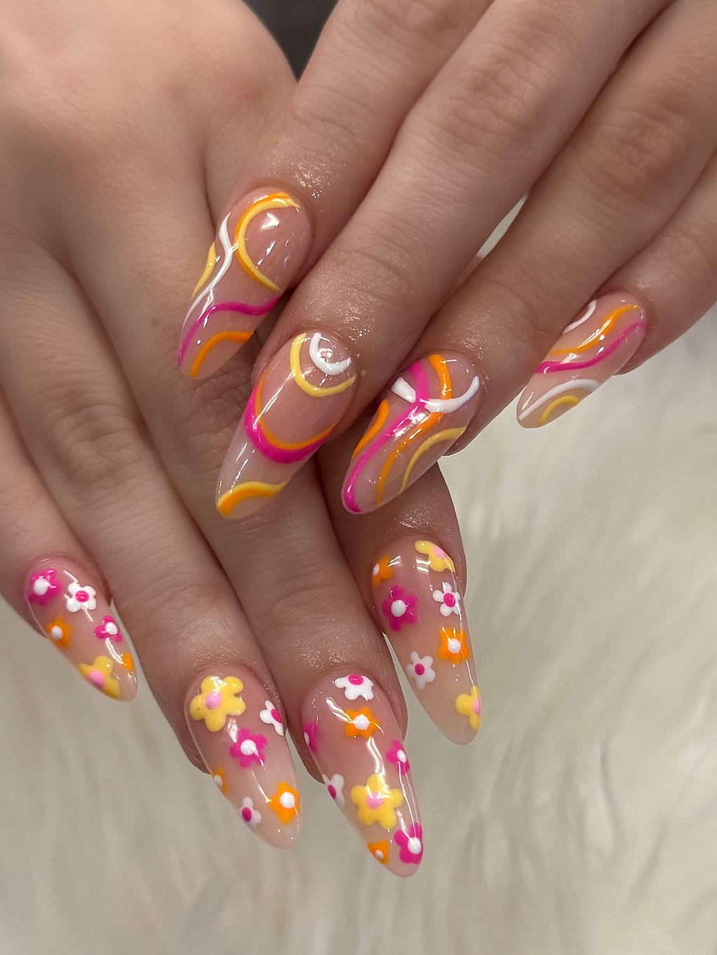 Bright orange, pink, and white floral nail art at Palace Nail Spa in Midtown Tallahassee