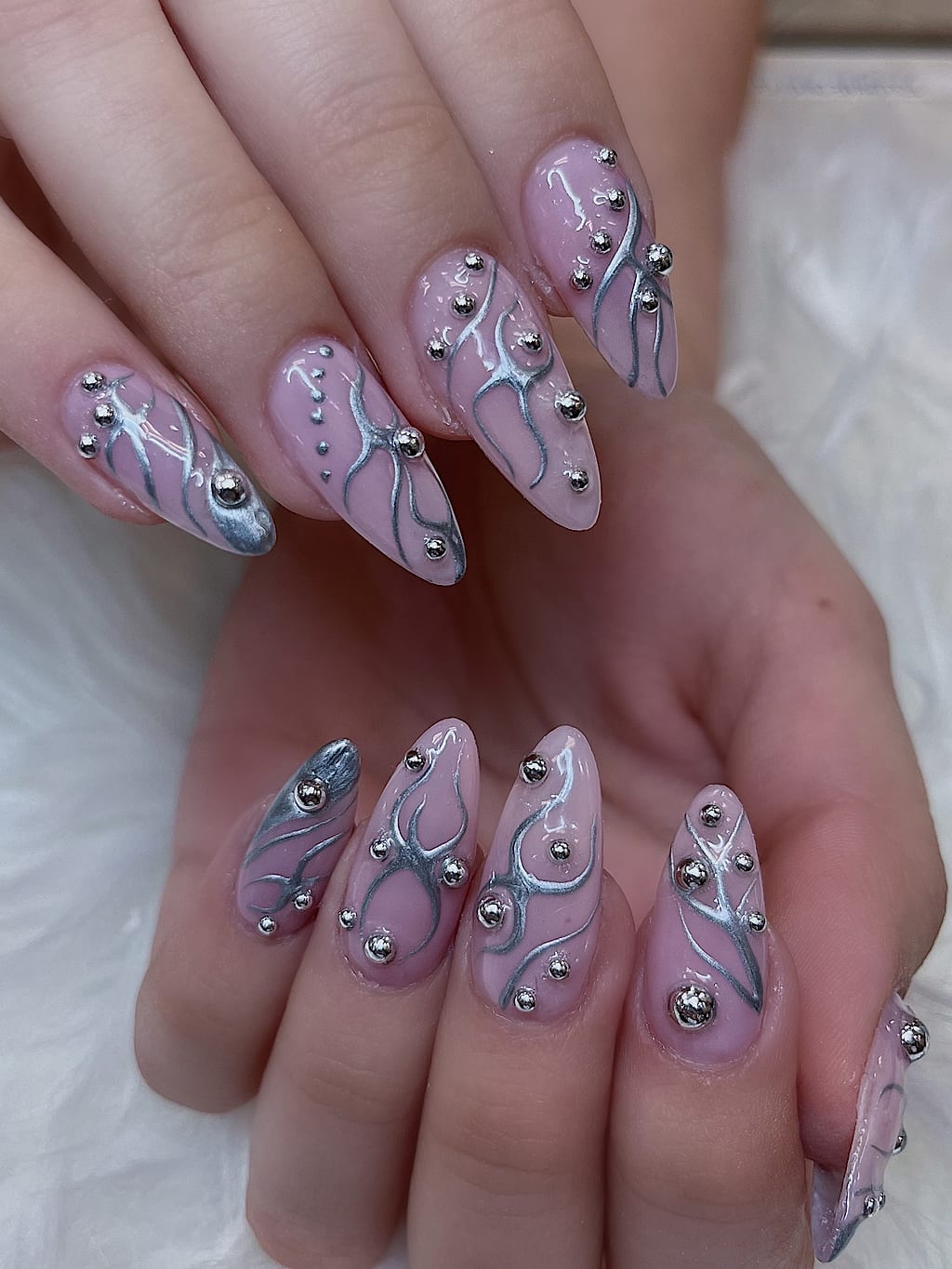 Nude nails with silver freehand swirls and bead accents at Palace Nail Spa in Midtown Tallahassee