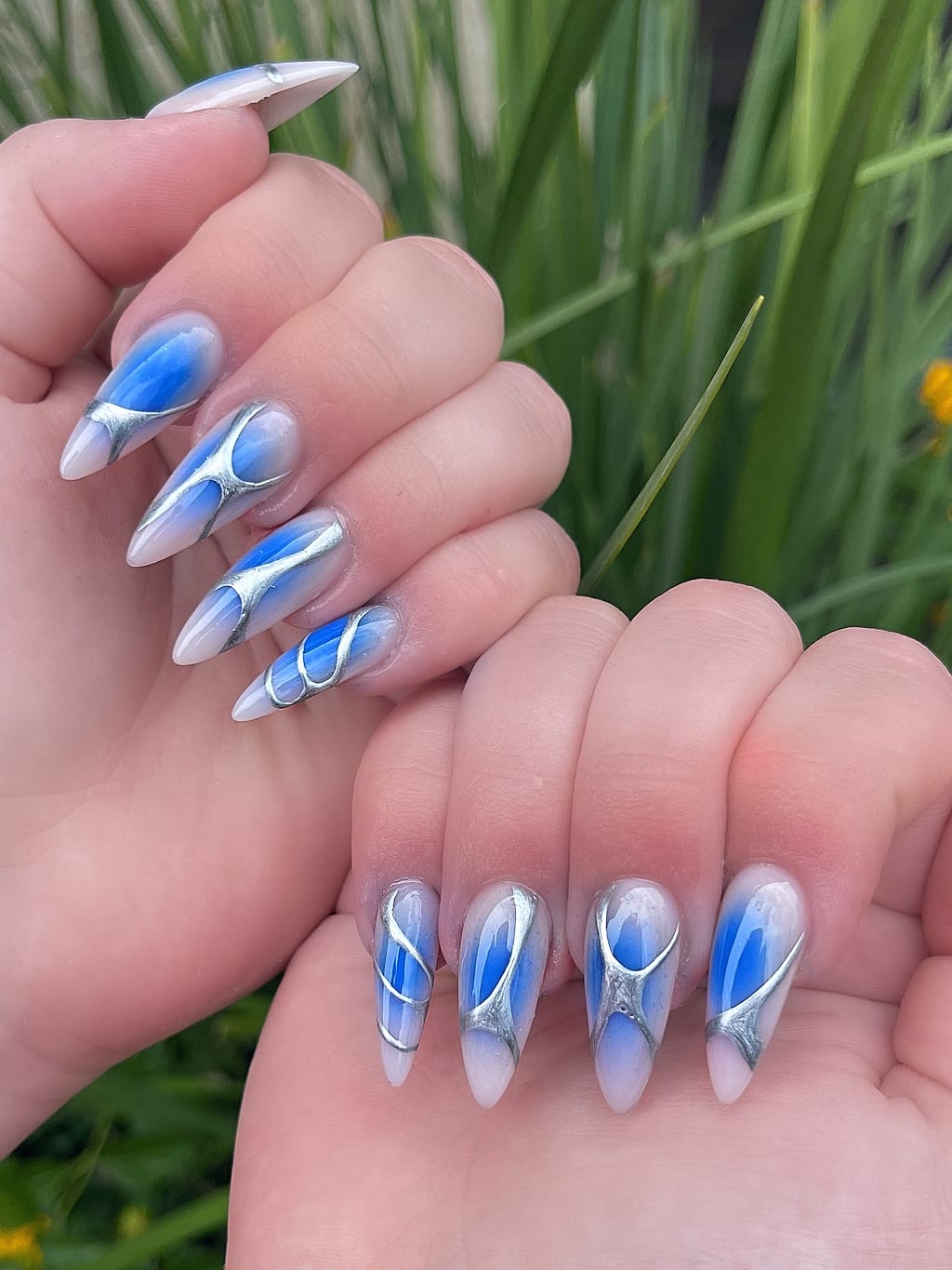 Blue and white marble nail art with chrome accents at Palace Nail Spa in Midtown Tallahassee