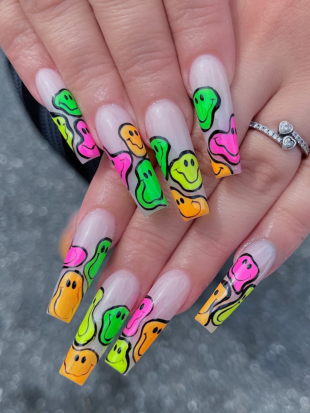 Coffin nails with colorful melting smiley face graffiti art at Palace Nail Spa in Midtown Tallahassee