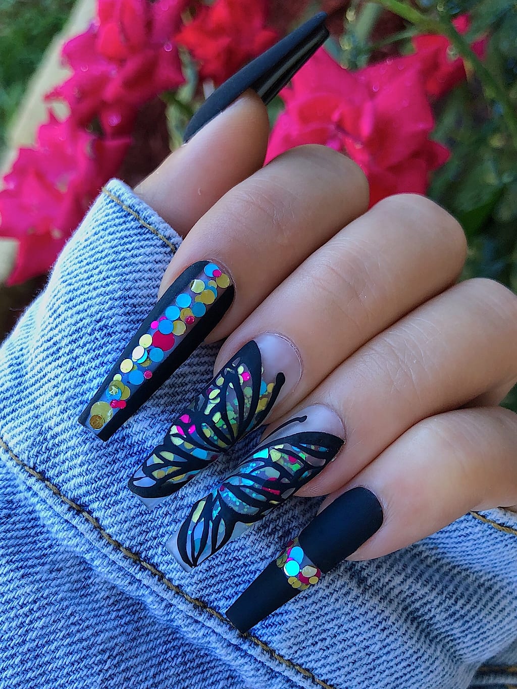 Black coffin nails featuring a blue butterfly design at Palace Nail Spa in Midtown Tallahassee