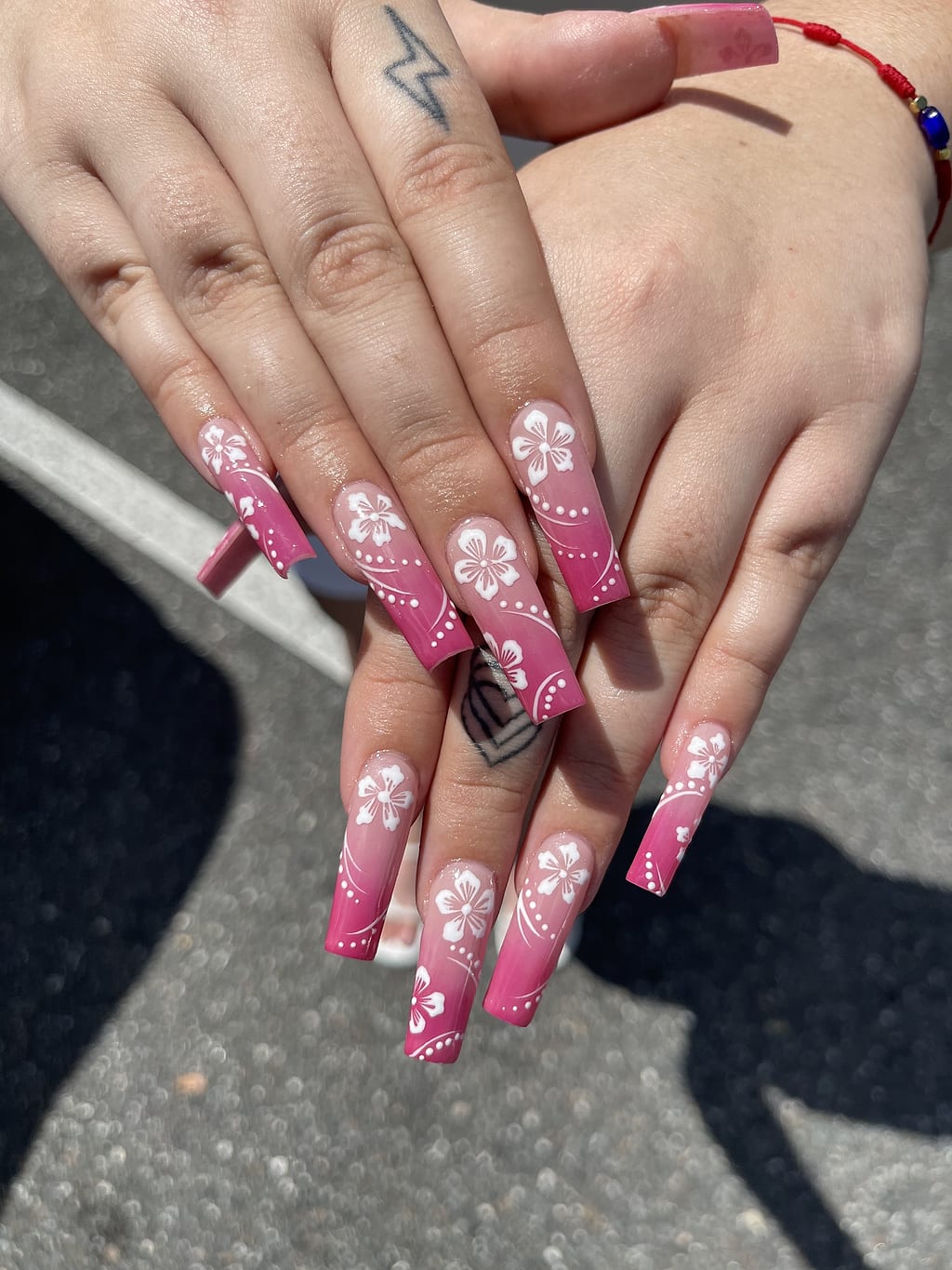Pink coffin nails with white floral French tip design at Palace Nail Spa in Midtown Tallahassee