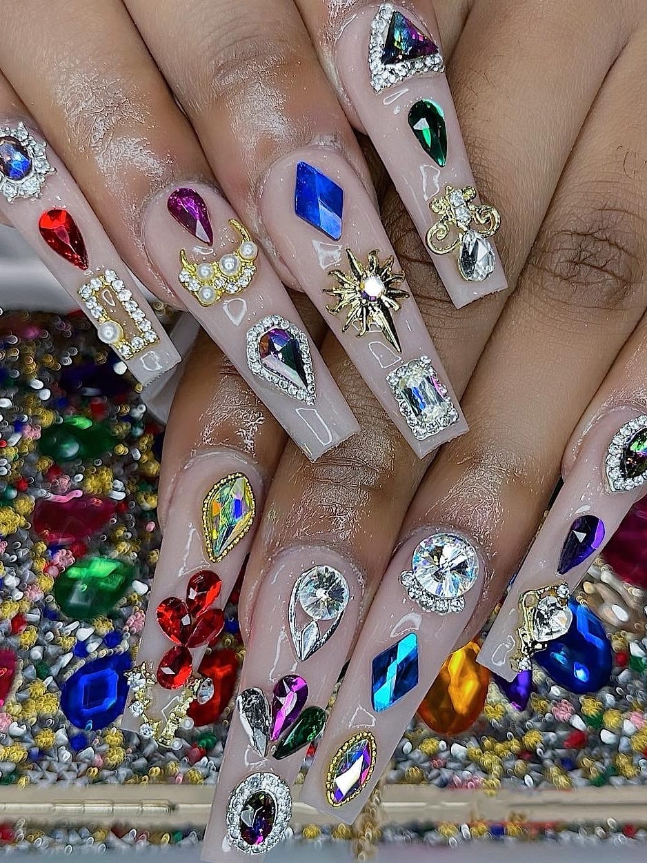 Fully bedazzled multicolor gem nails with a matching clutch at Palace Nail Spa in Midtown Tallahassee