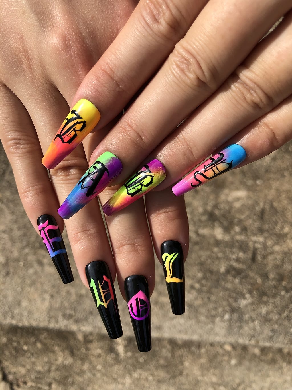 Coffin nails with multicolor graffiti swirls and black accents at Palace Nail Spa in Midtown Tallahassee