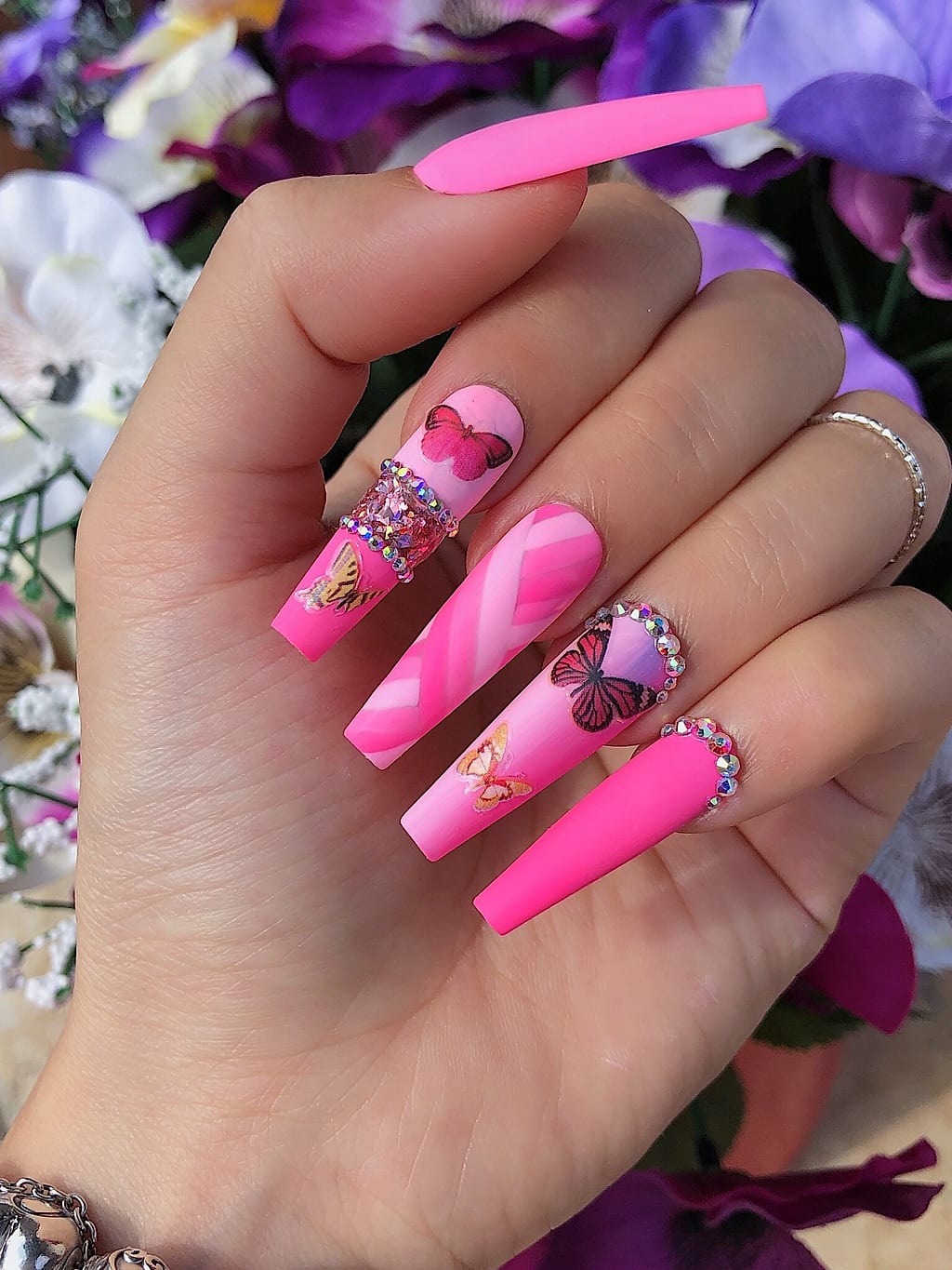 Pink ombre coffin nails with white butterflies and gems at Palace Nail Spa in Midtown Tallahassee