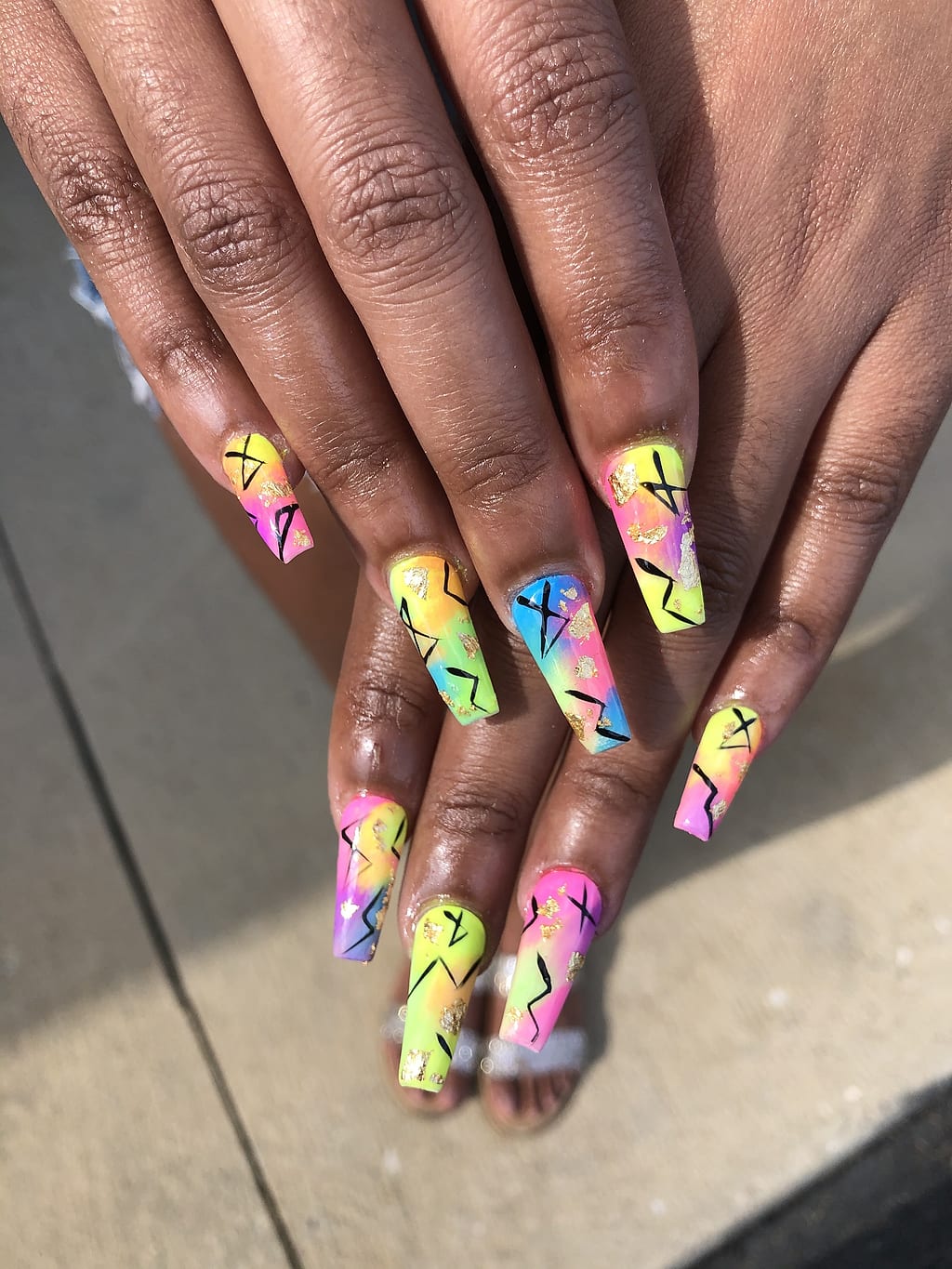 Black coffin nails with neon green and pink graffiti at Palace Nail Spa in Midtown Tallahassee