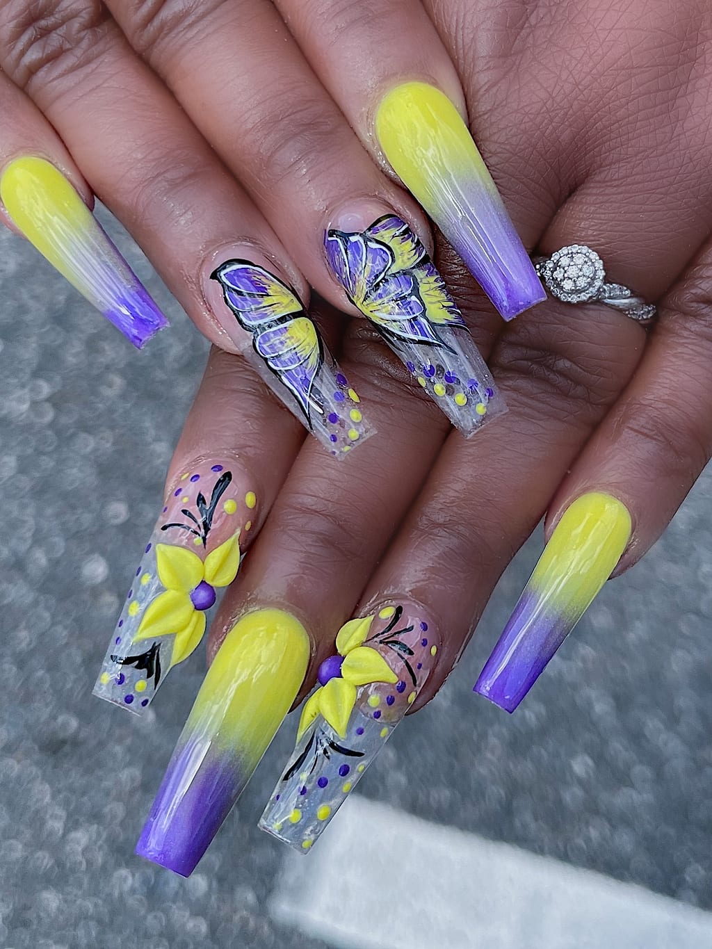 Coffin nails blend purple to yellow ombre with butterflies at Palace Nail Spa in Midtown Tallahassee