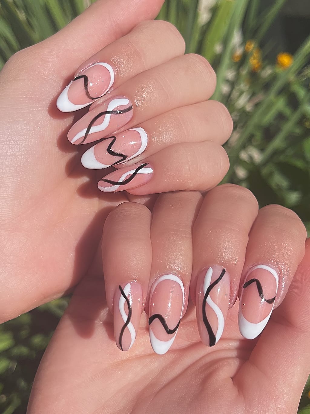 Nude nails with minimalist black-and-white swirl art at Palace Nail Spa in Midtown Tallahassee