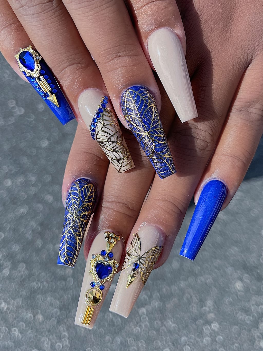 Coffin nails mix nude and navy with gold foil at Palace Nail Spa in Midtown Tallahassee