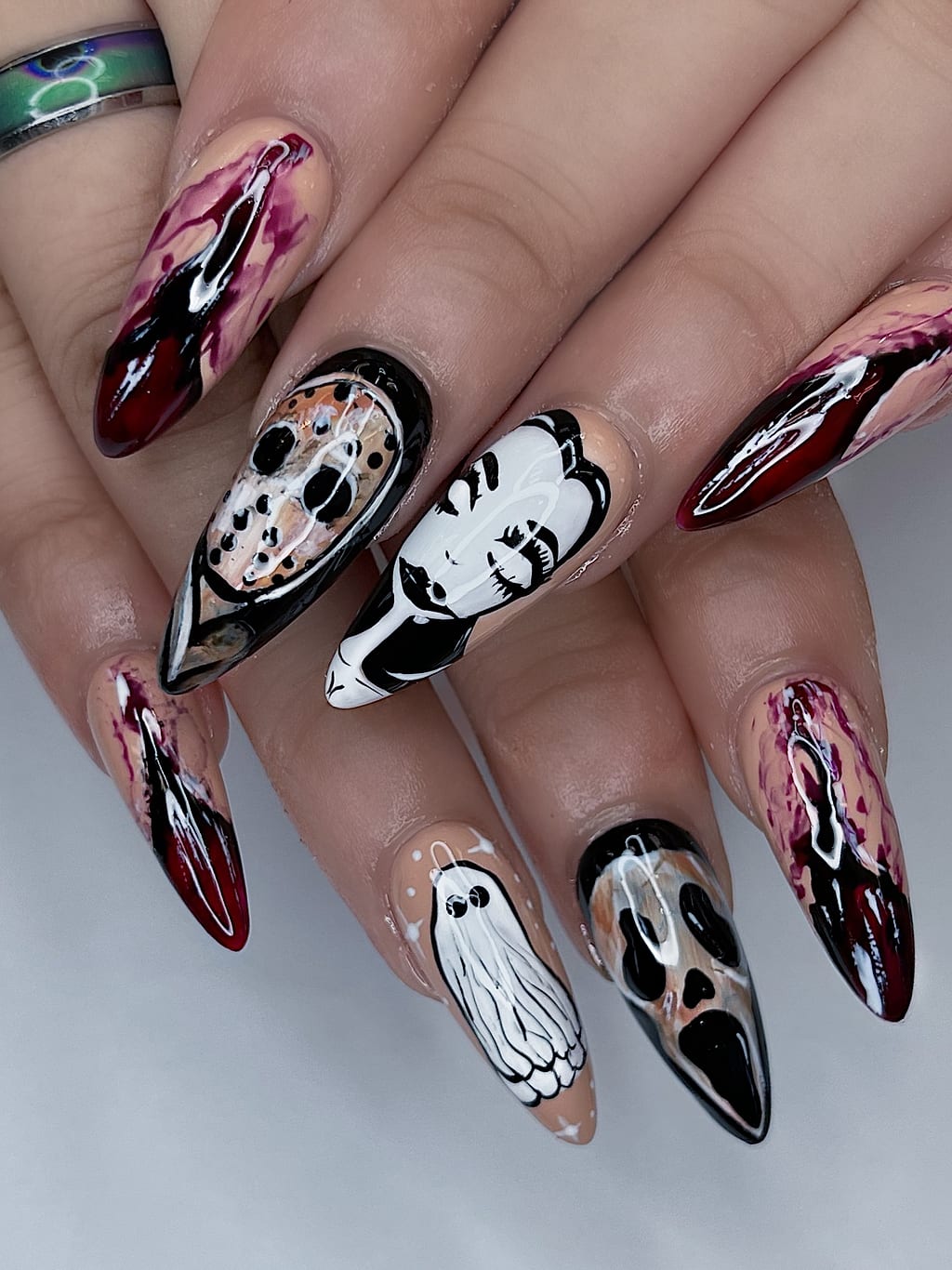 Nude almond nails feature black ghost and skull art at Palace Nail Spa in Midtown Tallahassee