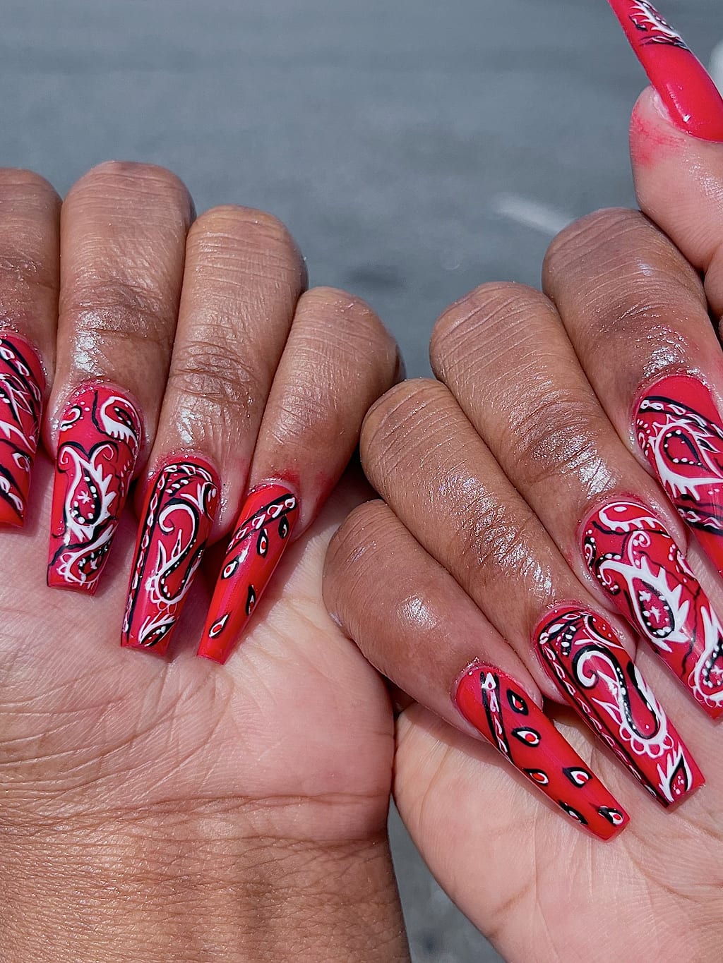 Red coffin nails feature black and white paisley print at Palace Nail Spa in Midtown Tallahassee