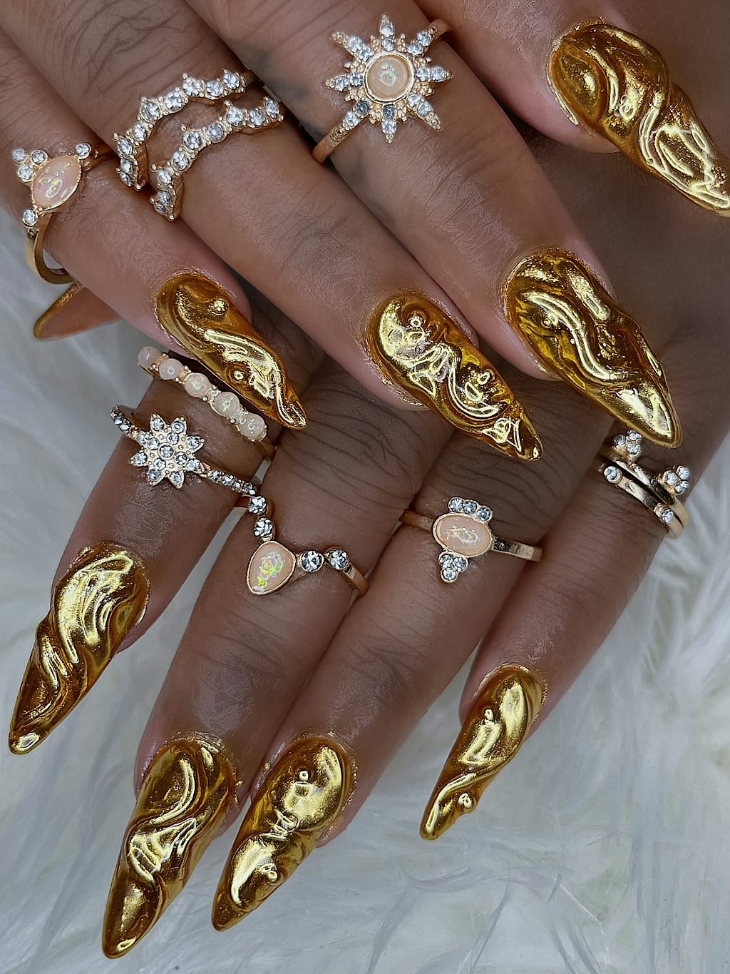 Long stiletto nails shine in a gold chrome finish at Palace Nail Spa in Midtown Tallahassee