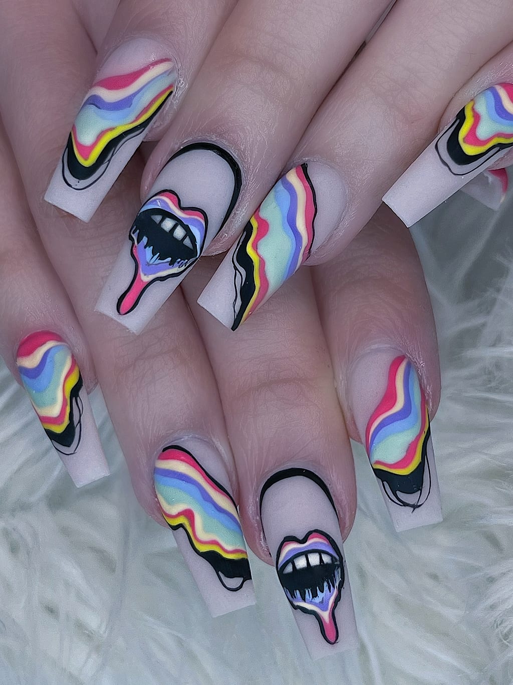Black and white nails feature dripping rainbow lips art at Palace Nail Spa in Midtown Tallahassee