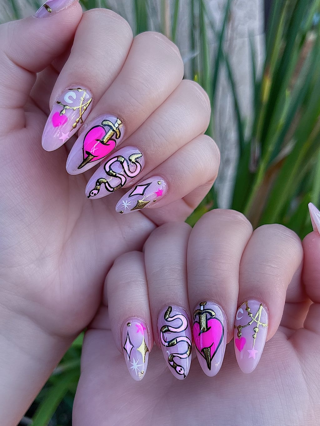 Nude coffin nails feature heart and snake line art at Palace Nail Spa in Midtown Tallahassee