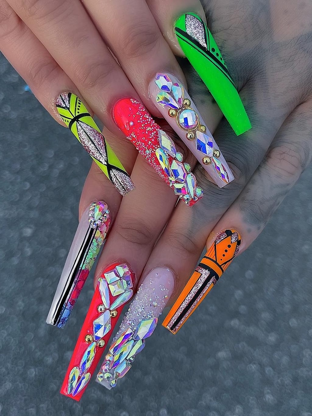 Bright neon coffin nails feature colorful graffiti style art at Palace Nail Spa in Midtown Tallahassee