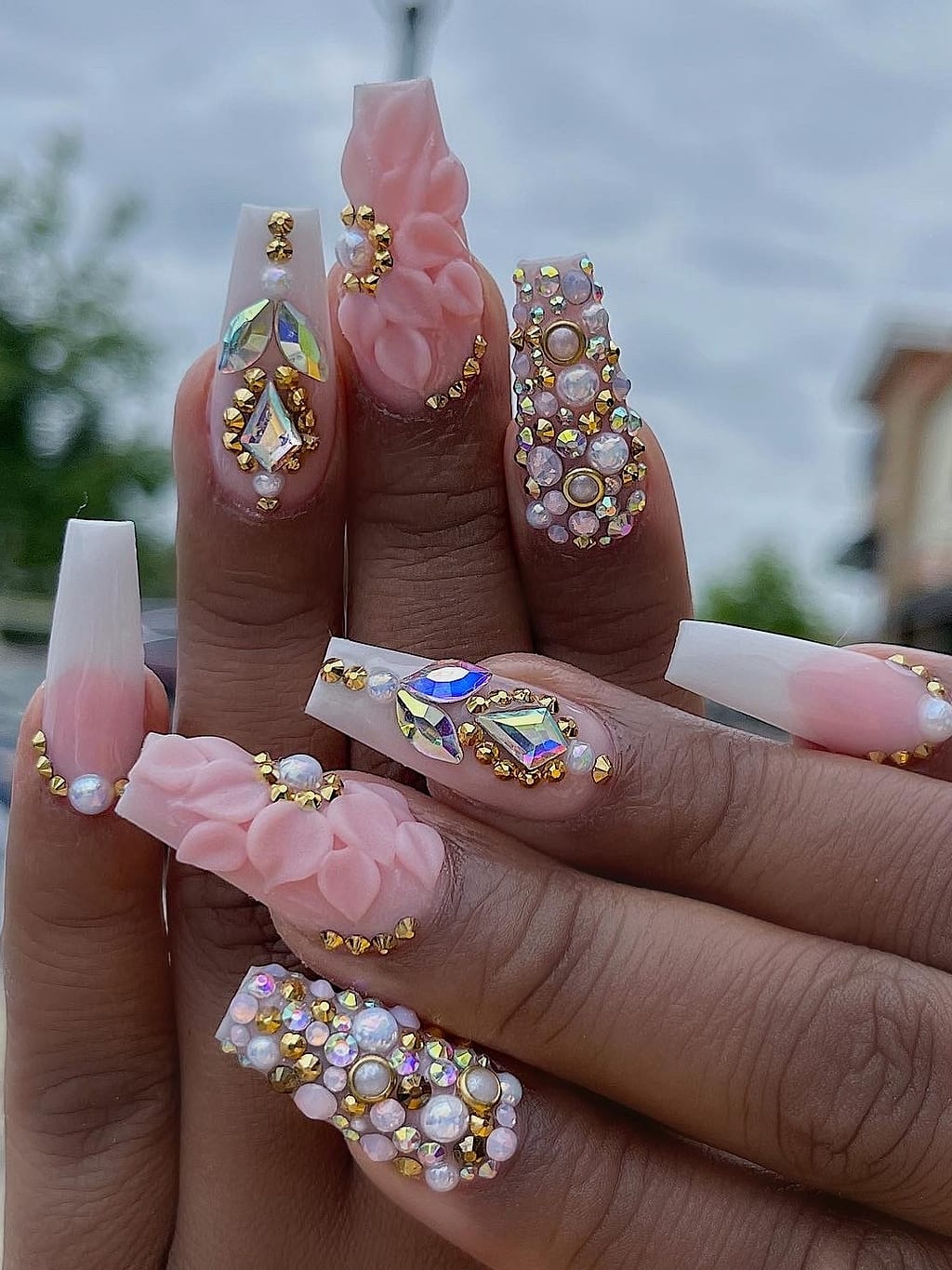 Nude coffin nails feature pearls rhinestones and a 3D bow accent at Palace Nail Spa