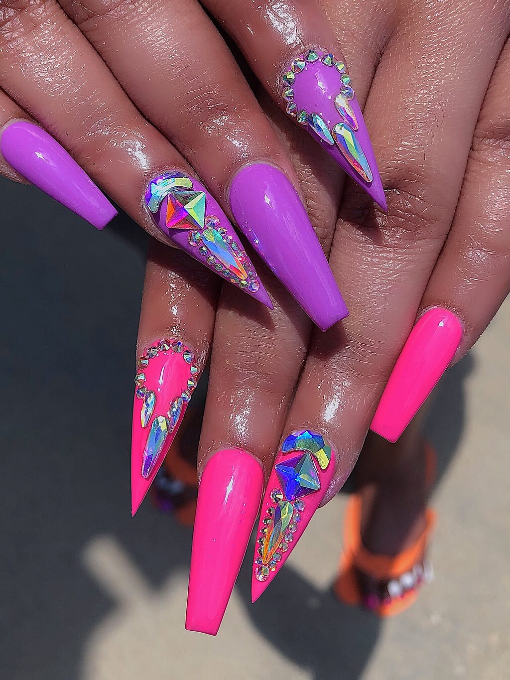 Purple and pink coffin nails feature abstract marbled art at Palace Nail Spa in Midtown Tallahassee