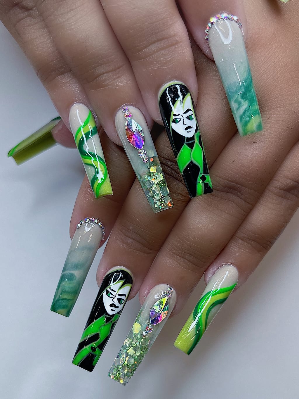 Green marble coffin nails feature a dark witchy figure at Palace Nail Spa in Midtown Tallahassee