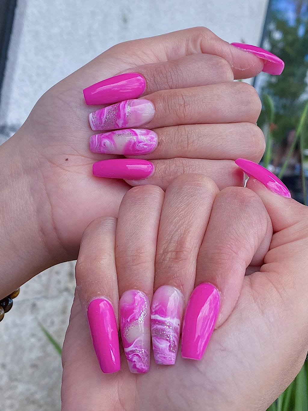 Hot pink marbled coffin nails with a glossy swirl at Palace Nail Spa in Midtown Tallahassee