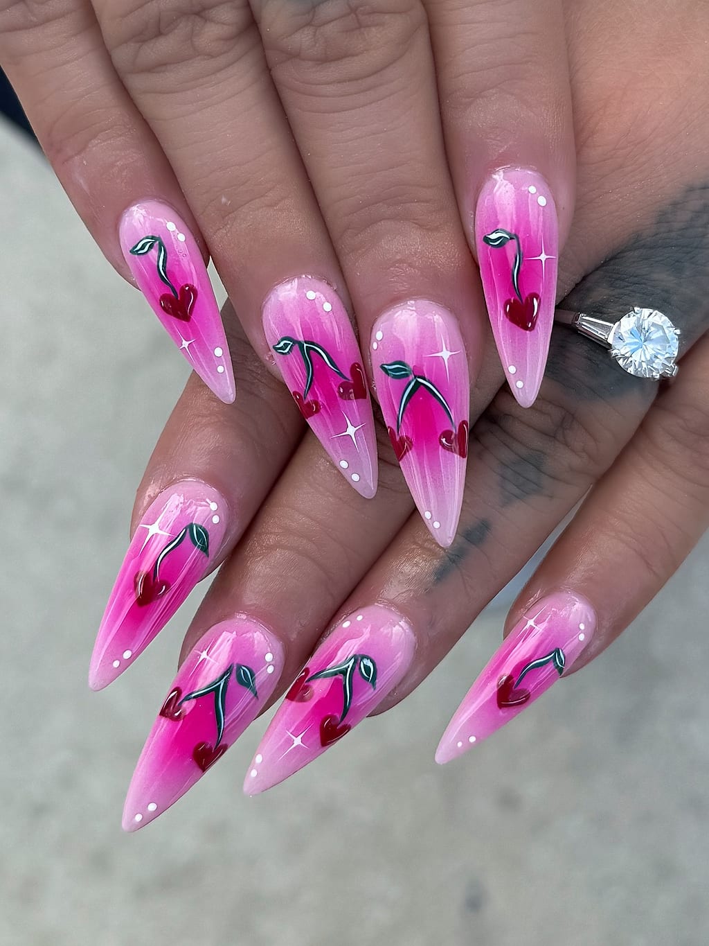 Pink ombre stiletto nails outlined with black heart designs at Palace Nail Spa in Midtown Tallahassee