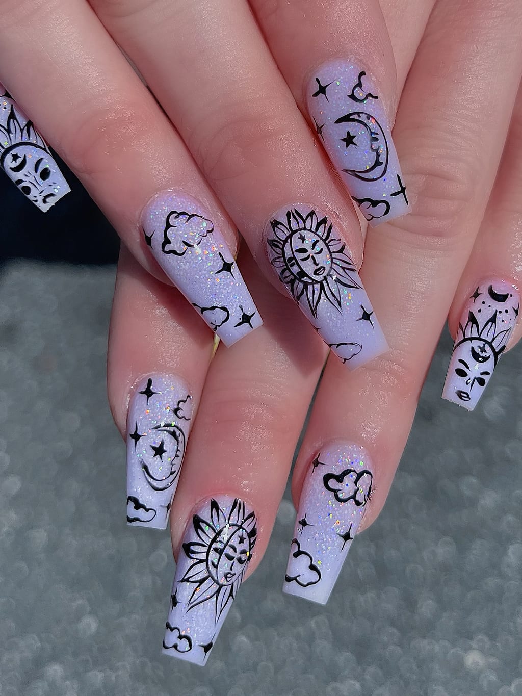 Sheer white coffin nails with black celestial line art at Palace Nail Spa in Midtown Tallahassee