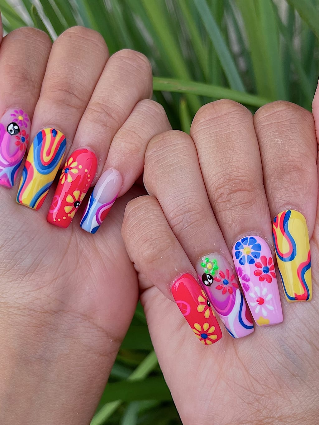 Coffin nails decorated with rainbow, flower, and abstract art at Palace Nail Spa in Midtown Tallahassee
