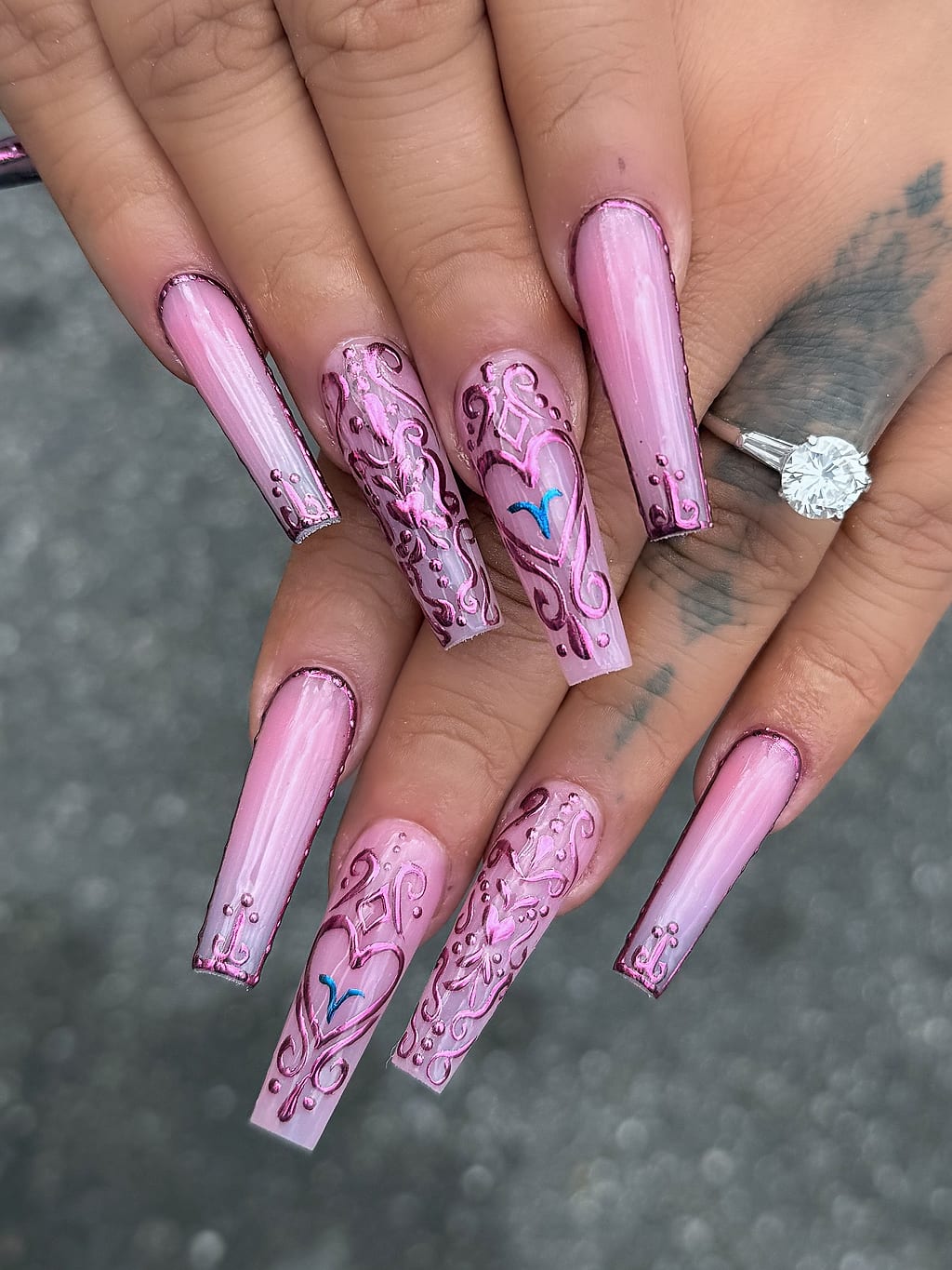 Pink coffin nails with delicate white floral line art at Palace Nail Spa in Tallahassee