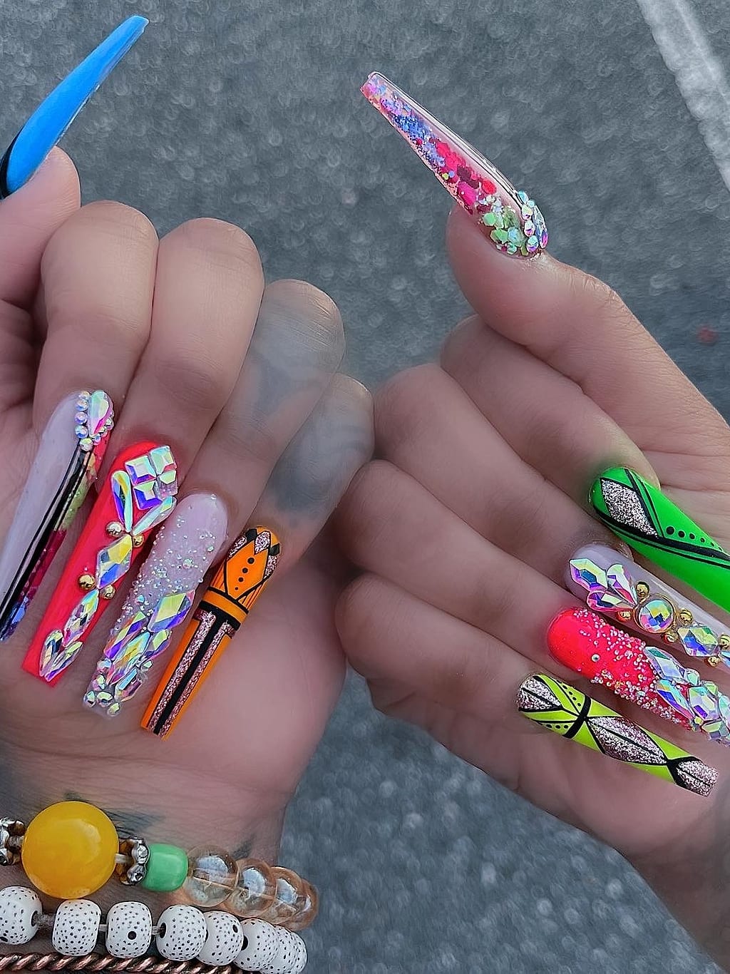 Colorful coffin nails feature fruit, butterfly, and mixed art at Palace Nail Spa in Midtown Tallahassee