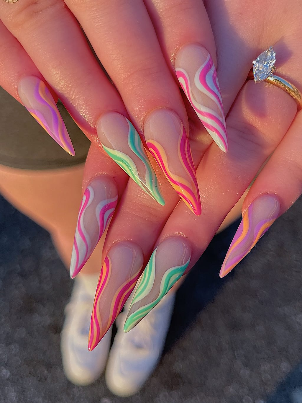 Nude stiletto nails with neon green, orange, pink swirls at Palace Nail Spa in Midtown Tallahassee