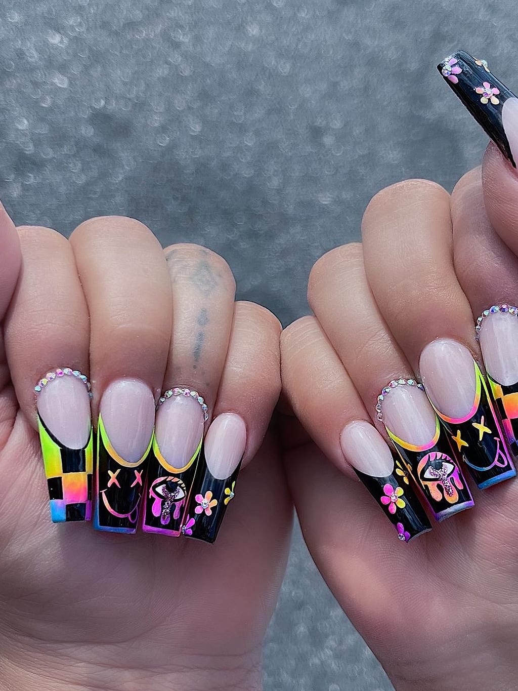 Black and nude coffin nails with colorful accent and floral art at Palace Nail Spa