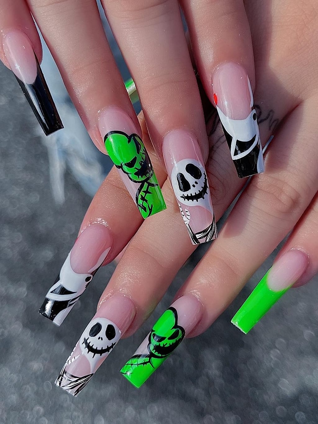 Black and green skeleton nail art on long coffin nails at Palace Nail Spa in Tallahassee