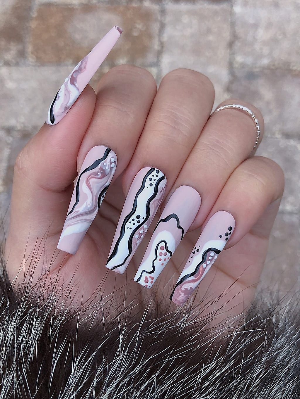 Nude coffin nails with black doodle line art at Palace Nail Spa in Midtown Tallahassee