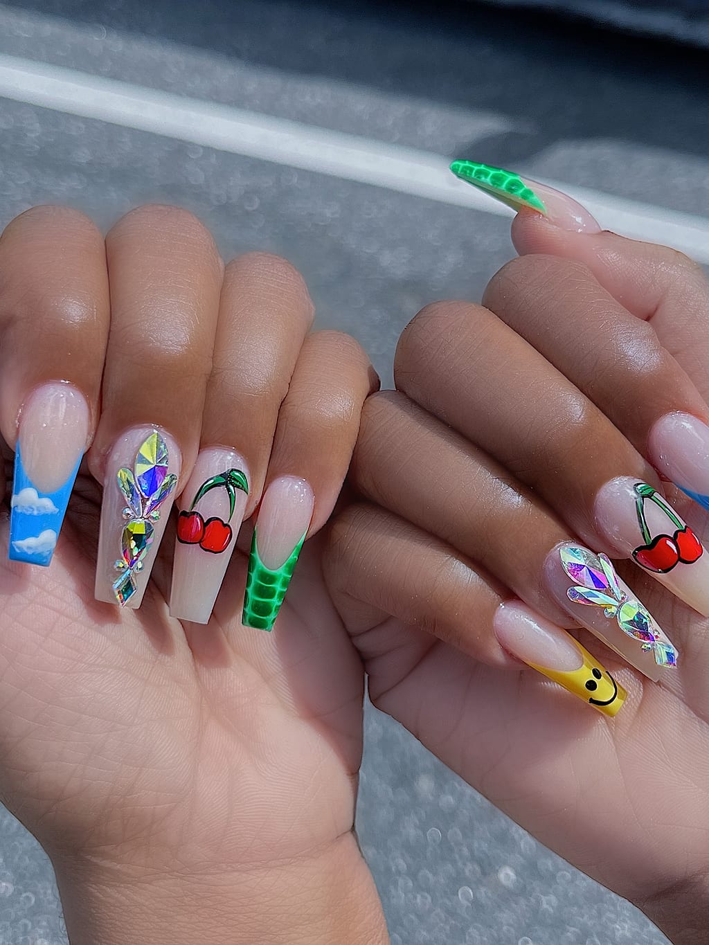 Nude nails with painted cherries and a smiley face at Palace Nail Spa in Midtown Tallahassee