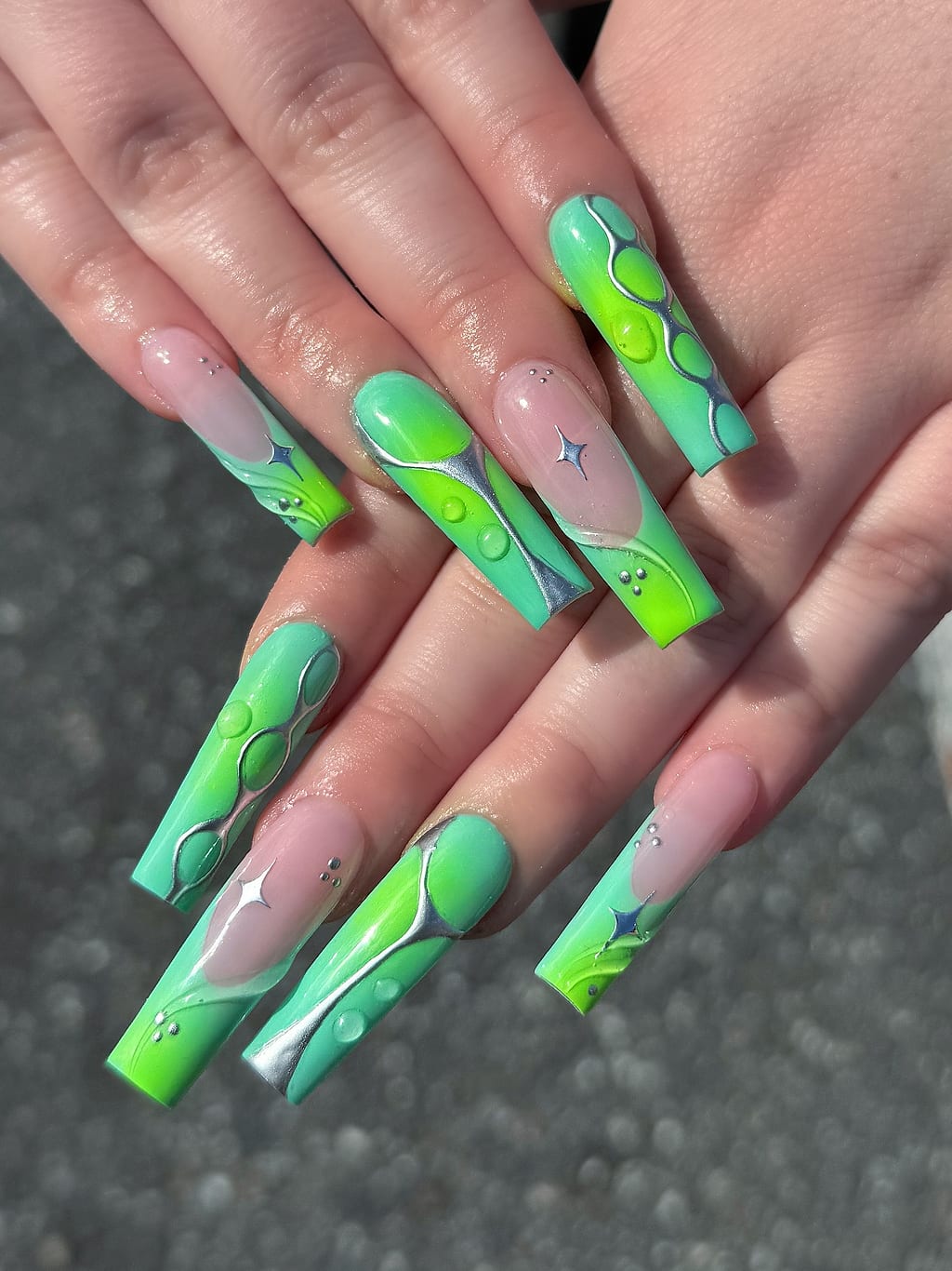Neon green coffin nails with white marbled swirl accents at Palace Nail Spa in Midtown Tallahassee