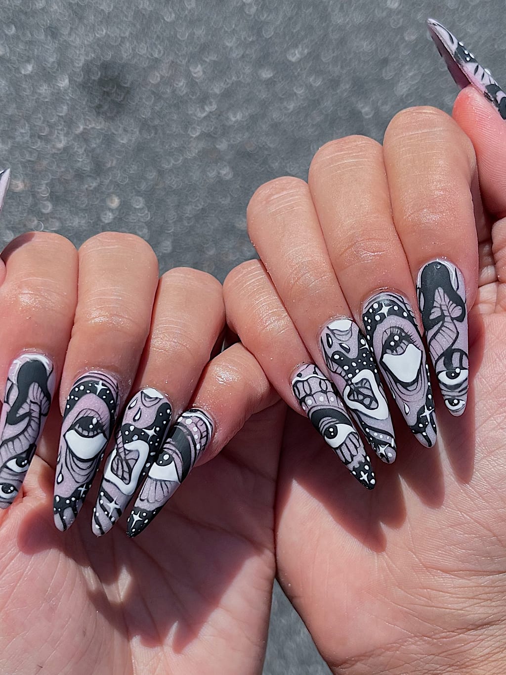 Black and white coffin nails with abstract line art at Palace Nail Spa in Midtown Tallahassee