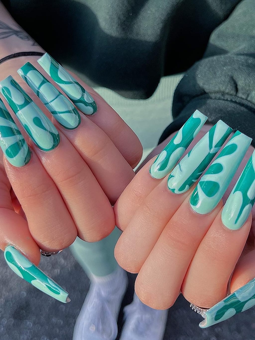 Nude coffin nails with teal abstract paint stroke art at Palace Nail Spa in Tallahassee