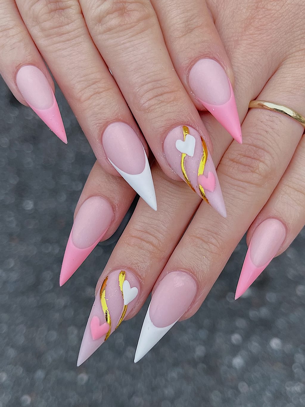 Nude and pink stiletto nails with gold heart accents at Palace Nail Spa in Midtown Tallahassee