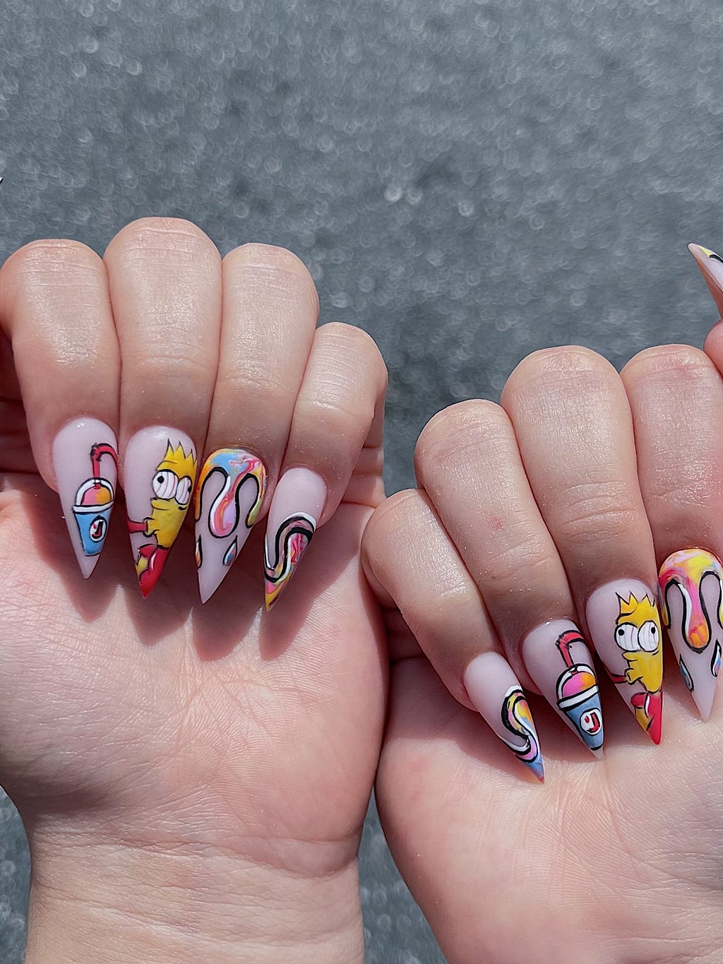 Nude stiletto nails with colorful cartoon character freehand art at Palace Nail Spa in Midtown Tallahassee