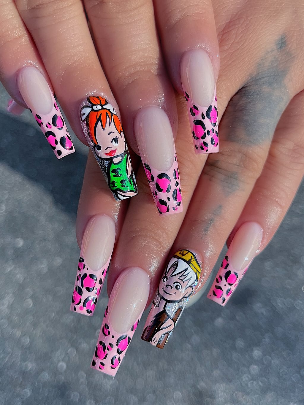 Nude coffin nails with leopard print and cartoon art at Palace Nail Spa in Midtown Tallahassee