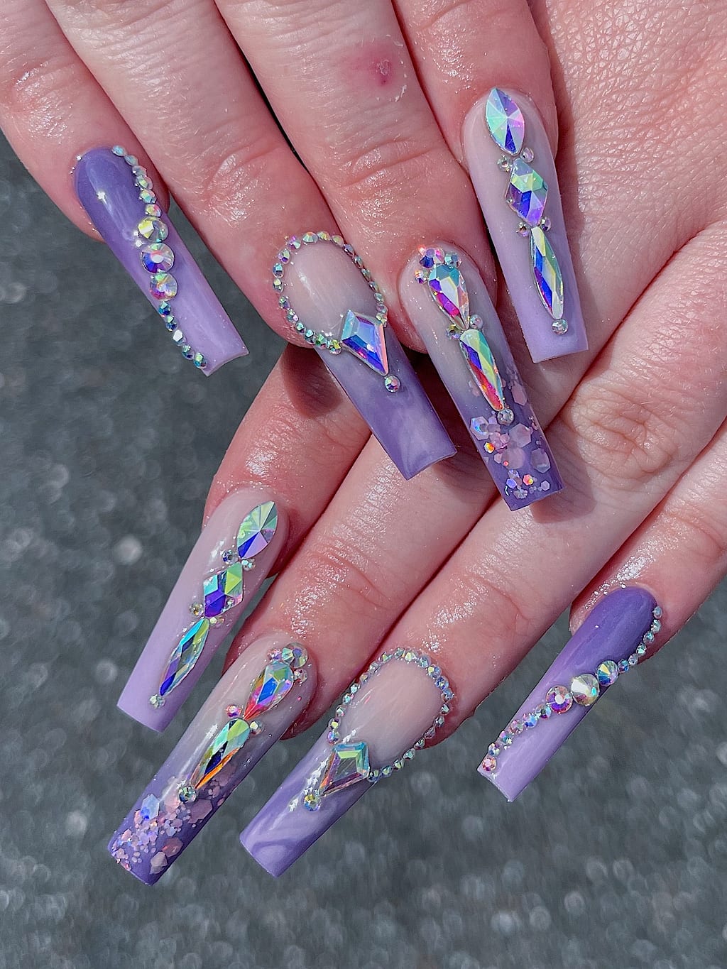Lavender coffin nails with iridescent chrome swirls and rhinestones at Palace Nail Spa