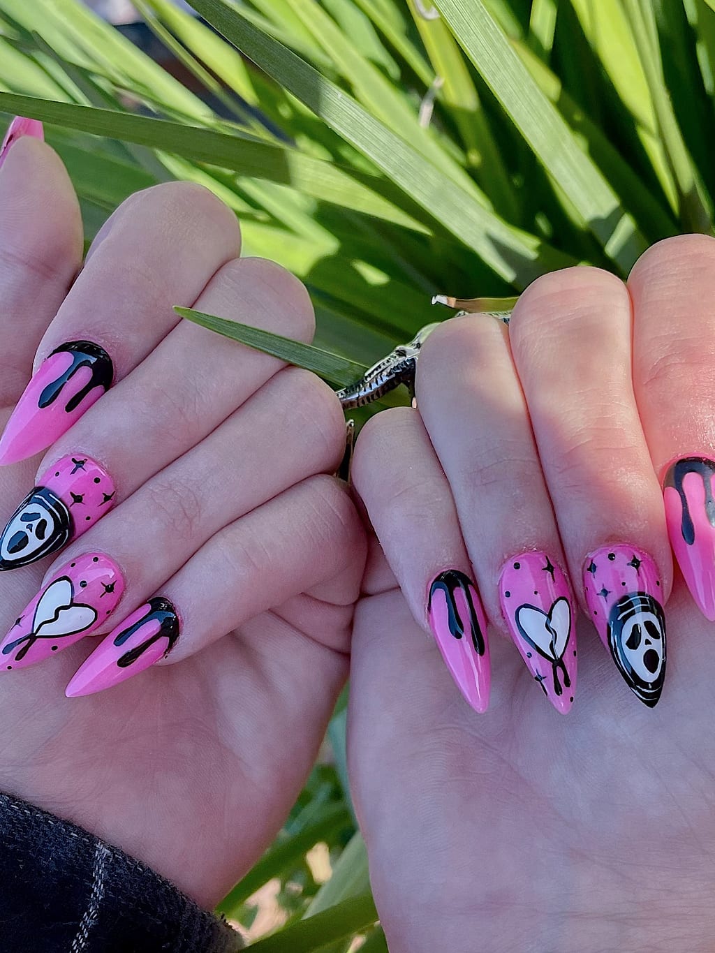 Pink and black almond nails with drippy heart designs at Palace Nail Spa in Midtown Tallahassee