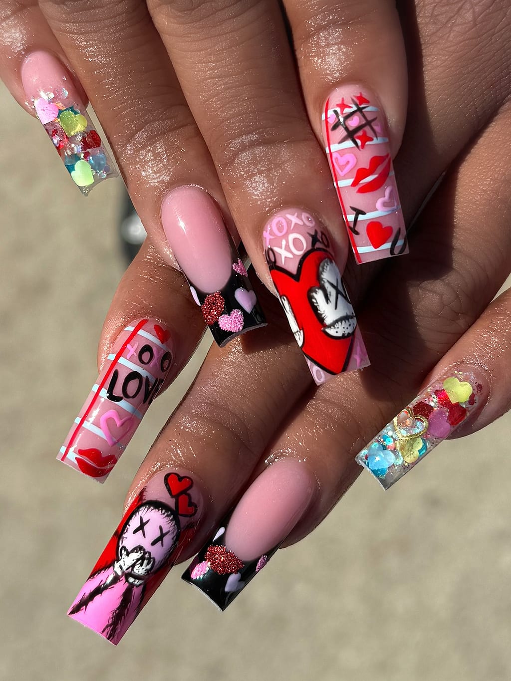 Pink and red coffin nails with hearts and skulls at Palace Nail Spa in Midtown Tallahassee