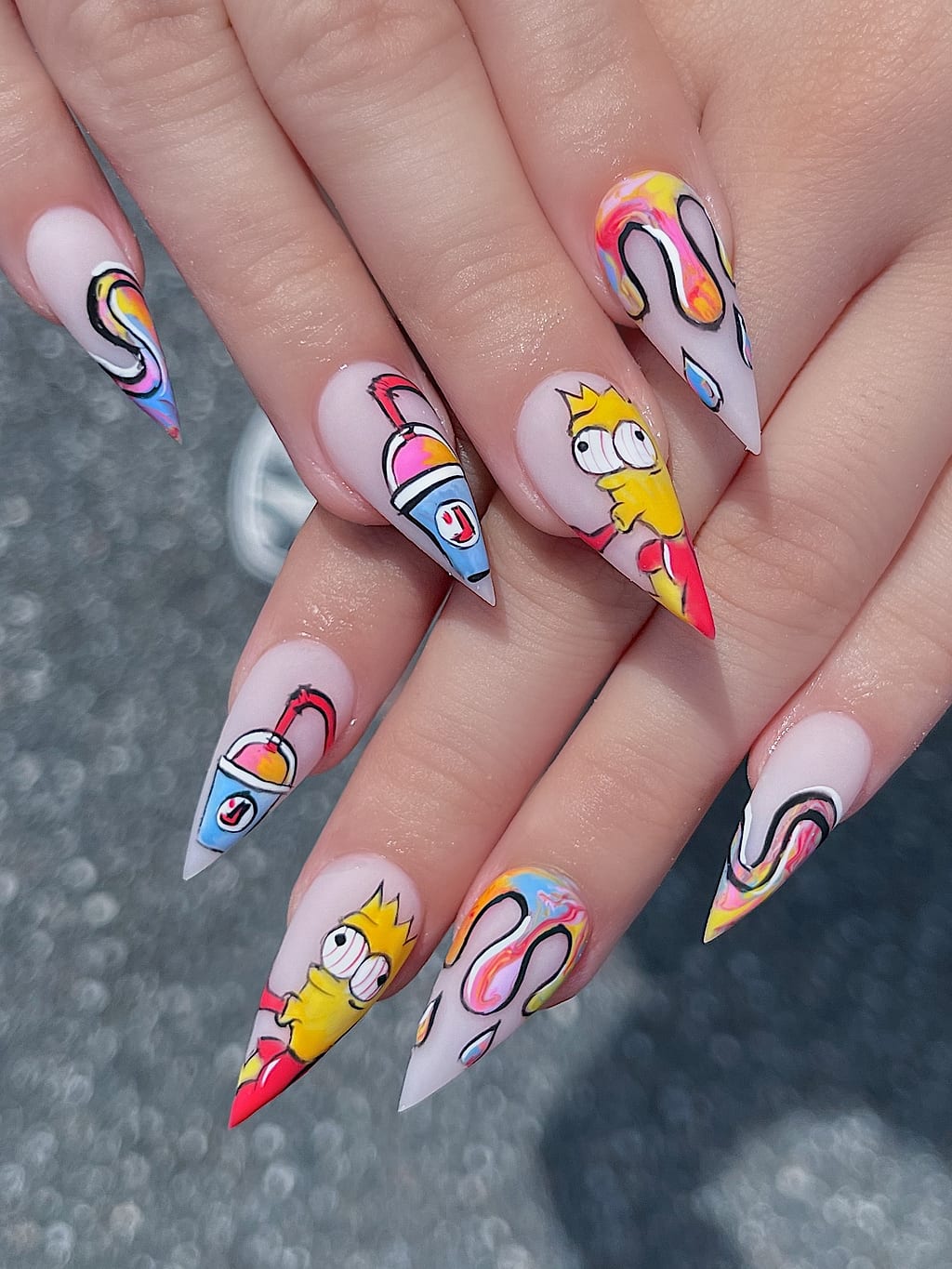 Nude coffin nails with colorful cartoon character art at Palace Nail Spa in Midtown Tallahassee