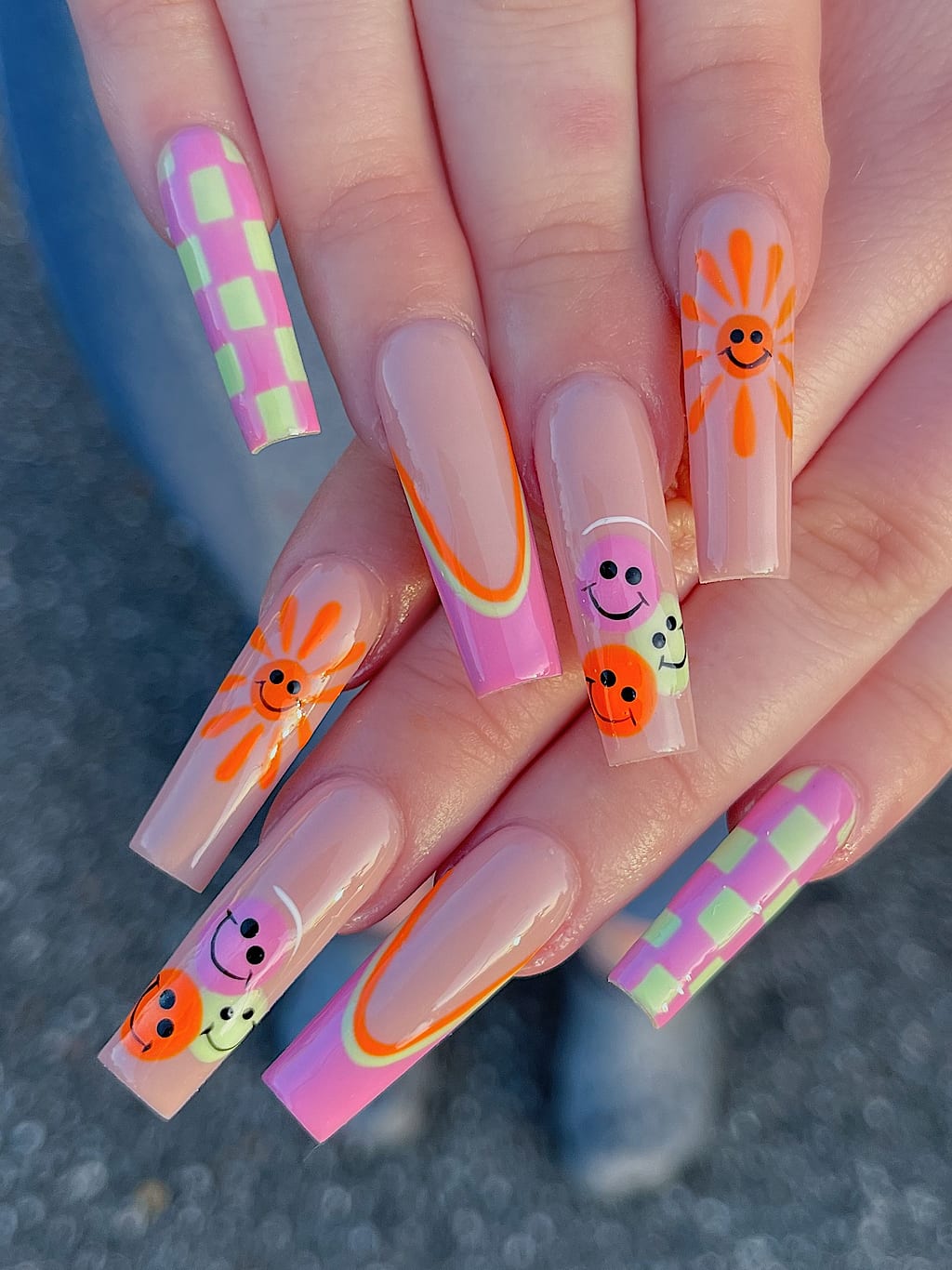 Nude coffin nails with green checkerboard and smiley accents at Palace Nail Spa in Midtown Tallahassee